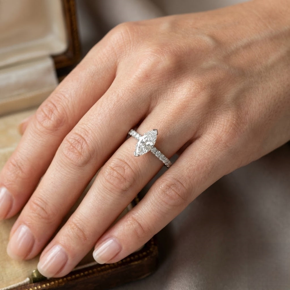 Elegant marquise cut diamond ring with pavé set shoulders