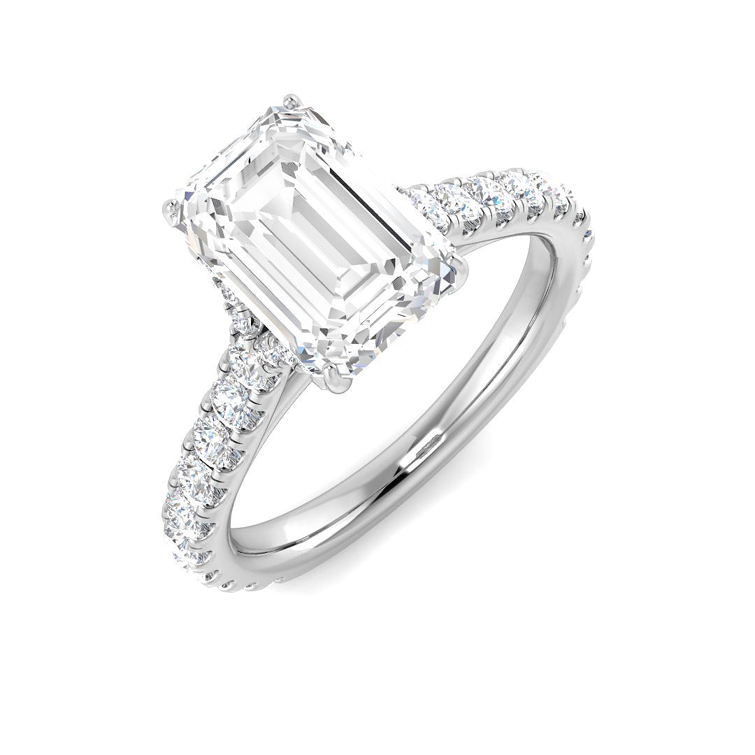 Emerald cut diamond engagement ring in white gold with prong set centre and diamond set shoulders