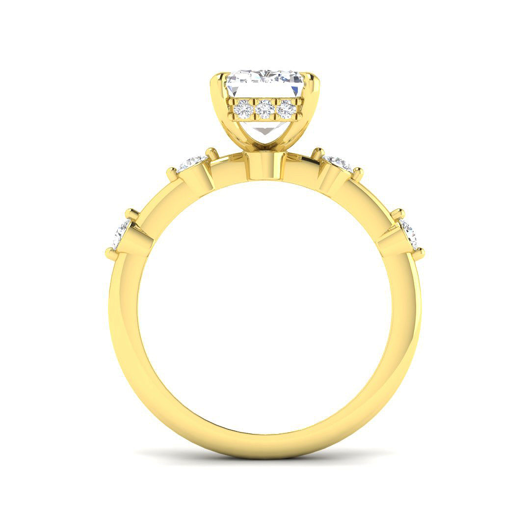 Emerald cut diamond ring featuring round diamond accents on polished band