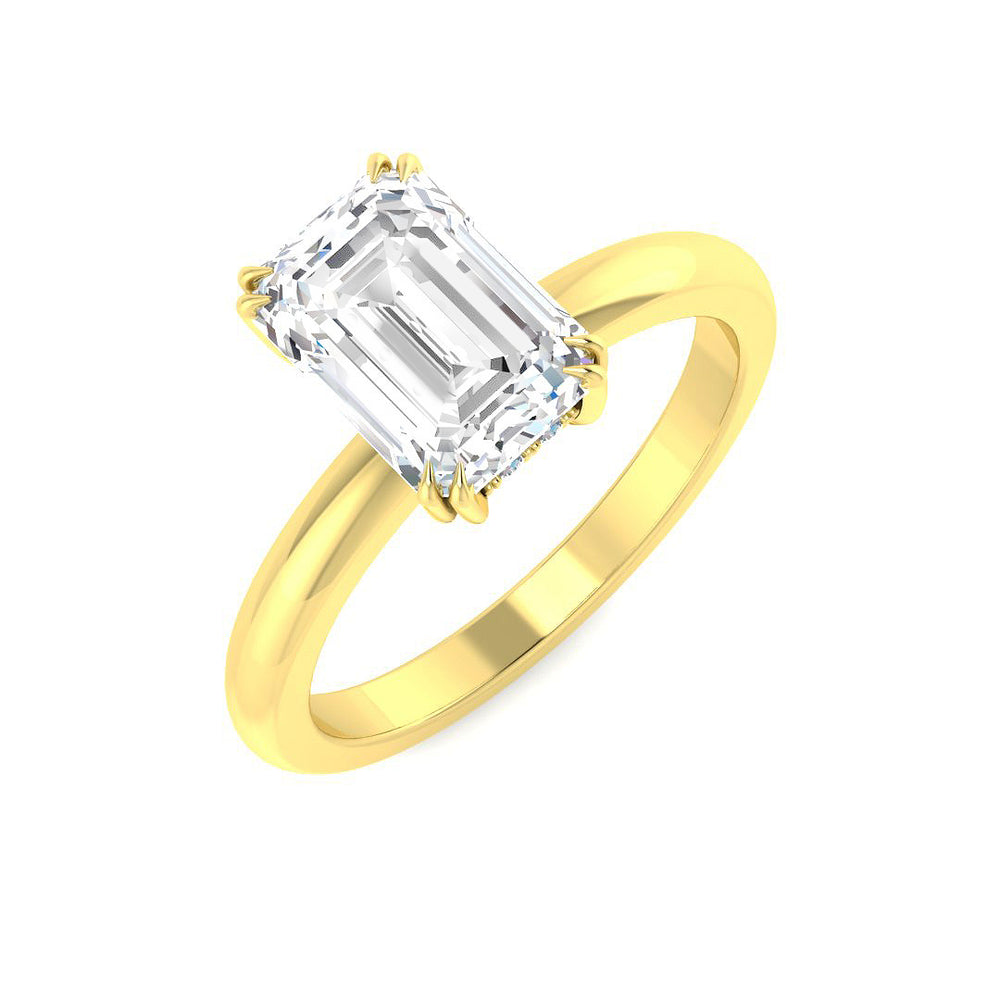Emerald cut diamond solitaire ring in yellow gold featuring a clean, minimalist setting