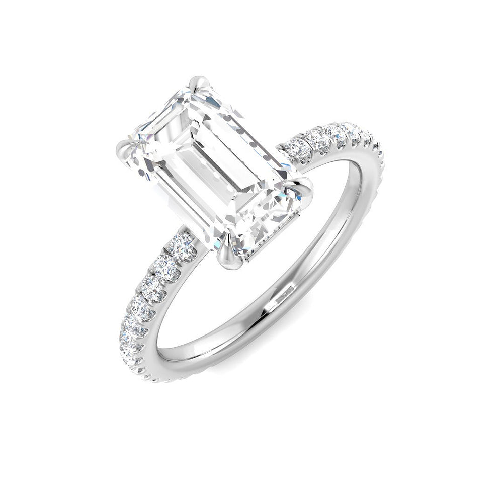 Emerald cut diamond solitaire engagement ring with pavé band in white gold. Featuring a natural diamond (F–G color, VS–SI clarity) or IGI certified lab grown diamond (D color, VVS clarity).