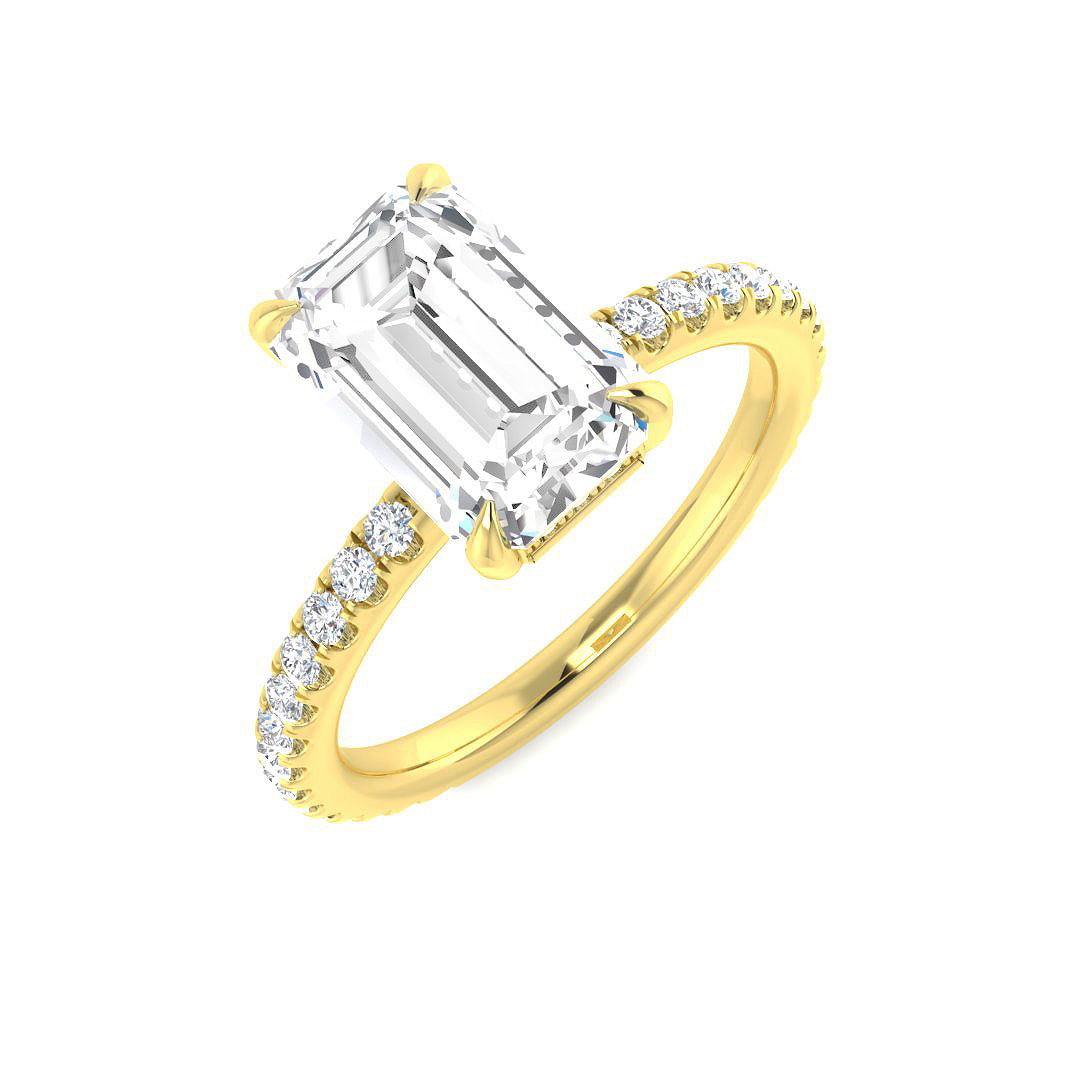 Emerald cut diamond solitaire engagement ring with pavé band in yellow gold, featuring natural diamond (F–G color, VS–SI clarity) or IGI certified lab grown diamond (D color, VVS clarity).
