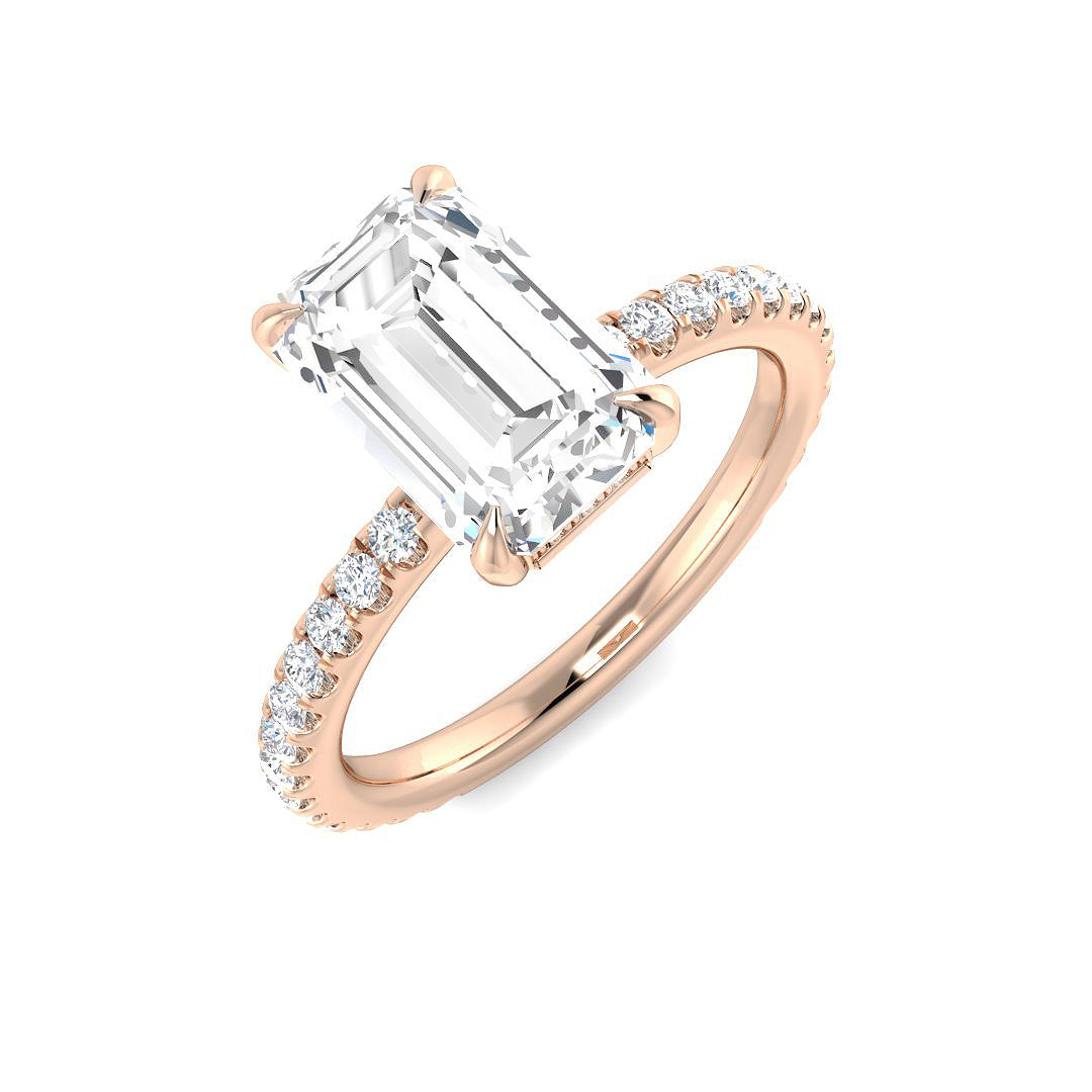 Elegant emerald cut diamond solitaire engagement ring with pavé band in rose gold, available with natural or IGI certified lab grown diamond (D color, VVS clarity).