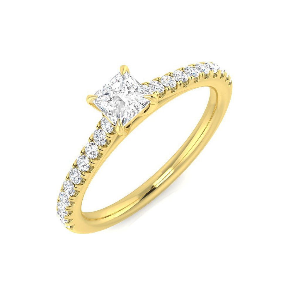 Gold ring with a central diamond and smaller diamonds along the band on a white background
