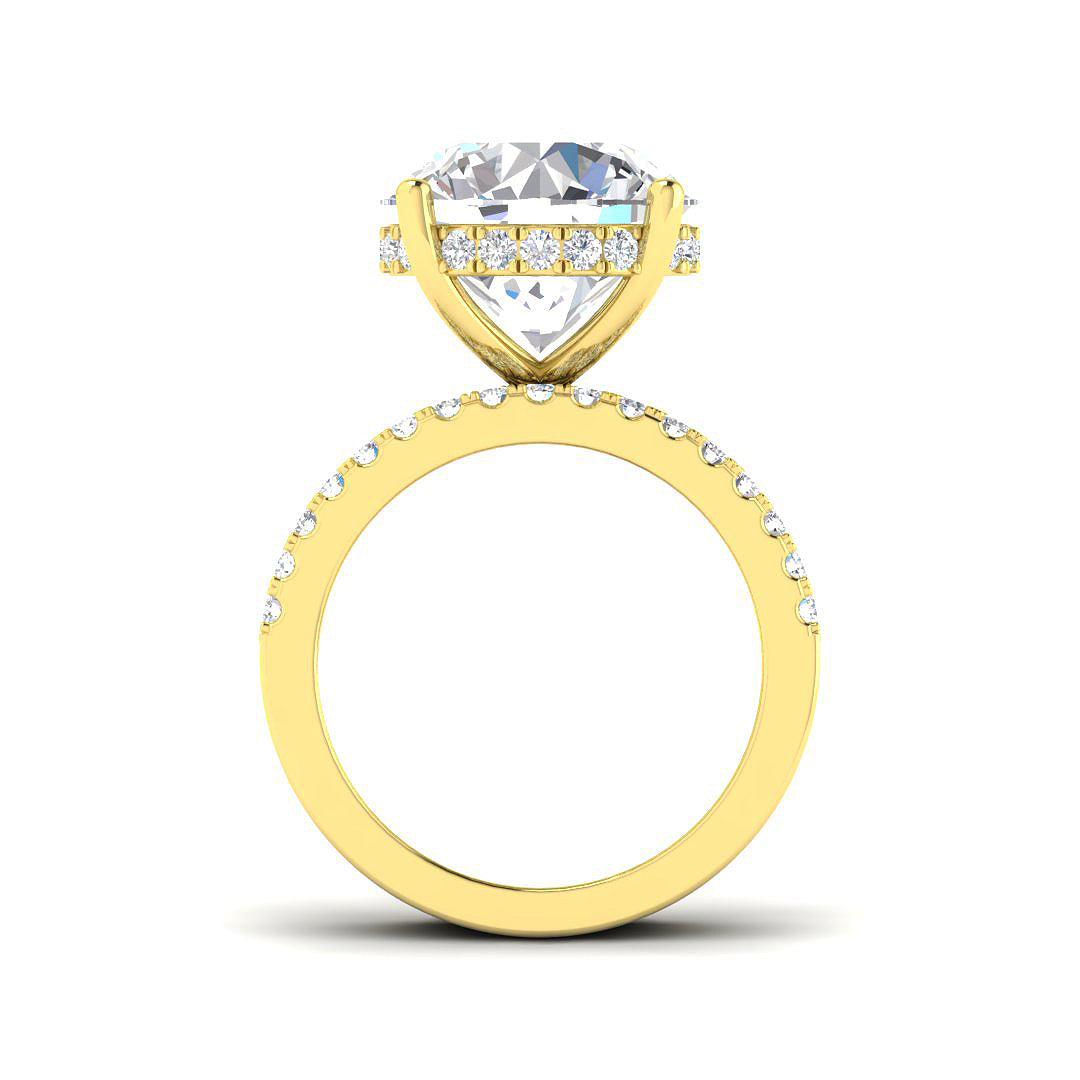 Gold ring with a large diamond and smaller diamonds on the band against a white background