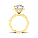 Gold ring with a large diamond and smaller diamonds on the band against a white background