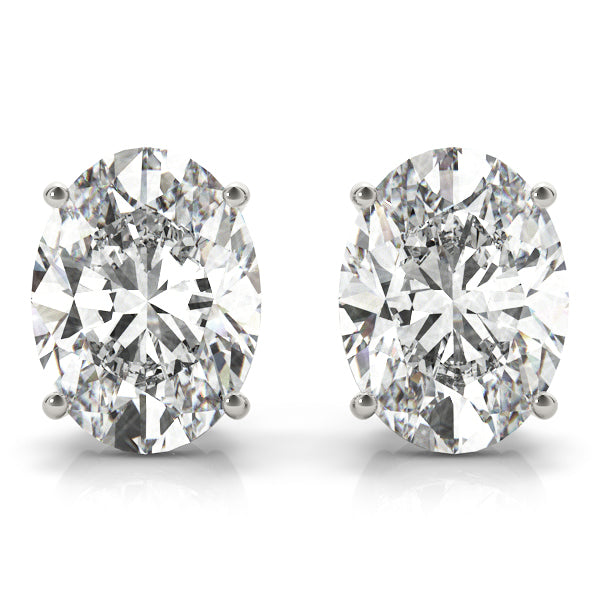 A pair of oval-cut lab-grown diamond stud earrings with a 4-prong setting in a white gold or platinum color, with a clear and vibrant appearance.