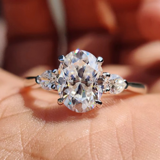 Oval Diamond and Pear Diamond Three Stone Engagement Ring