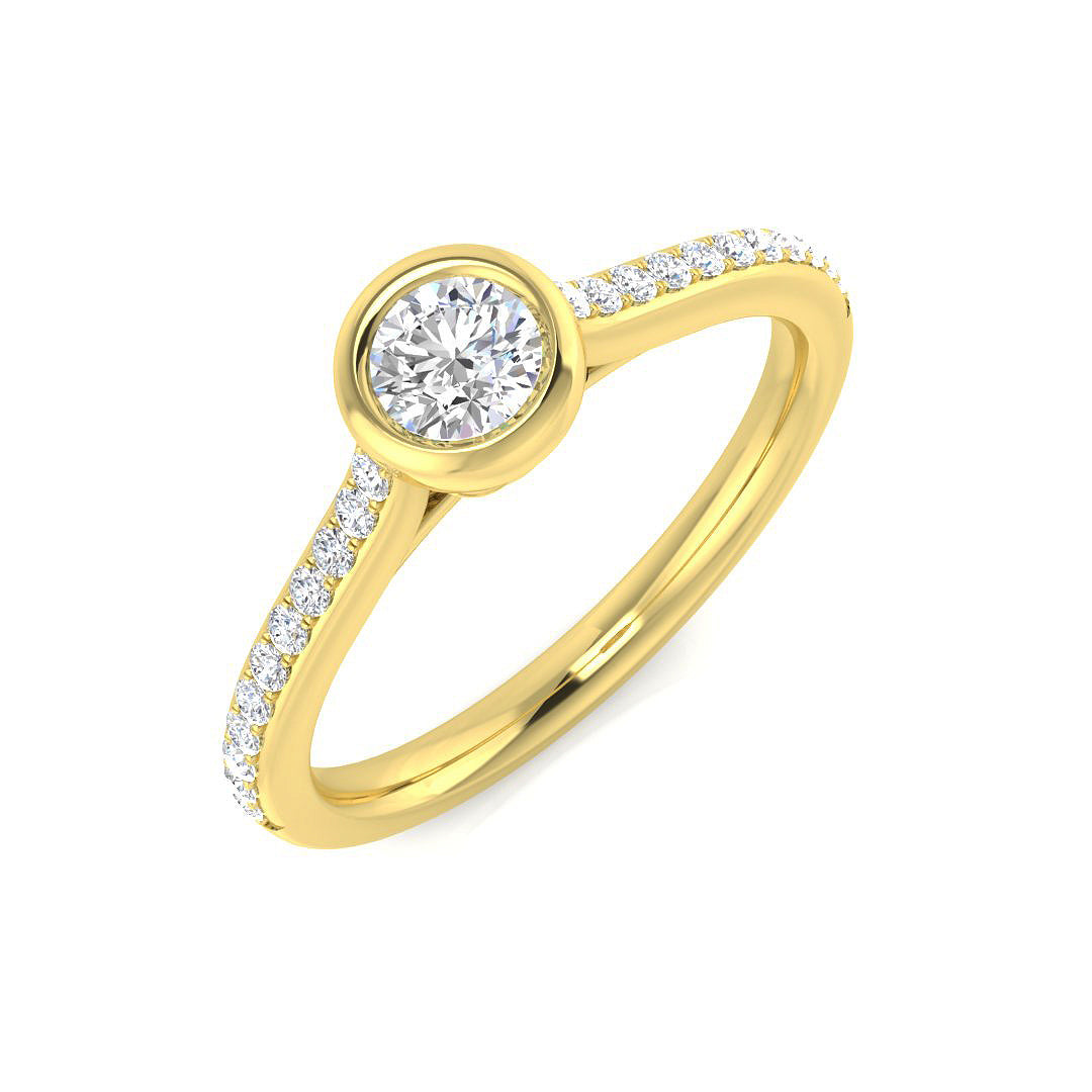 Round diamond bezel set solitaire ring with pavé band in yellow gold