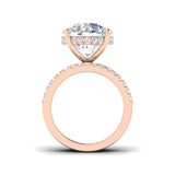 Rose gold ring with a large diamond and smaller diamonds on the band against a white background