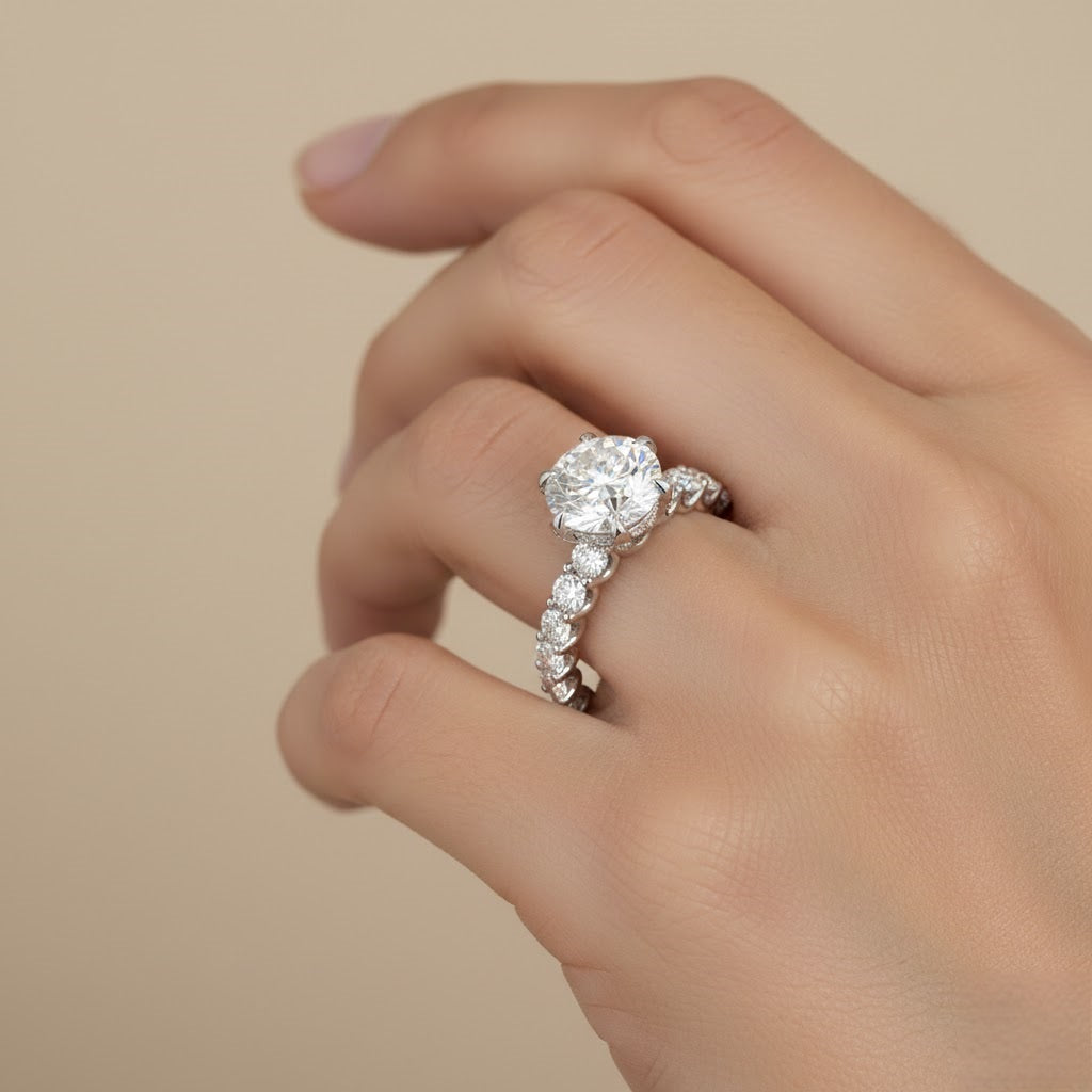 Round diamond solitaire ring with claw-set diamond shoulders