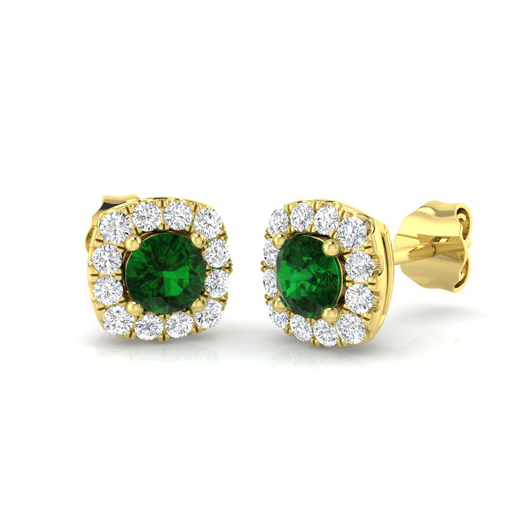 Round emerald stud earrings featuring pave set diamond halo