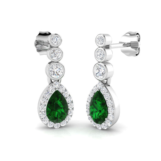 Green emerald teardrop earrings with diamond halo and round bezel set diamonds in white gold