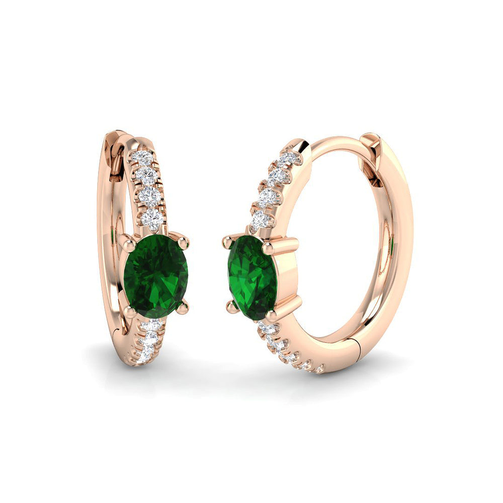 Emerald diamond hoop earrings in rose gold featuring oval emerald gemstones