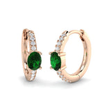 Emerald diamond hoop earrings in rose gold featuring oval emerald gemstones