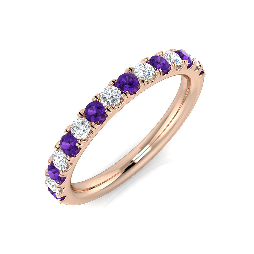Rose gold ring with purple and clear gemstones on a white background