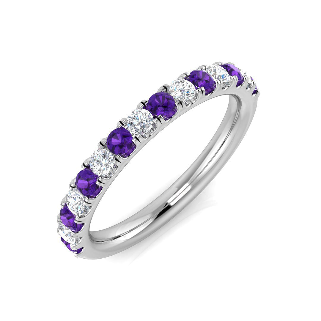 Silver ring with purple and clear gemstones on a white background