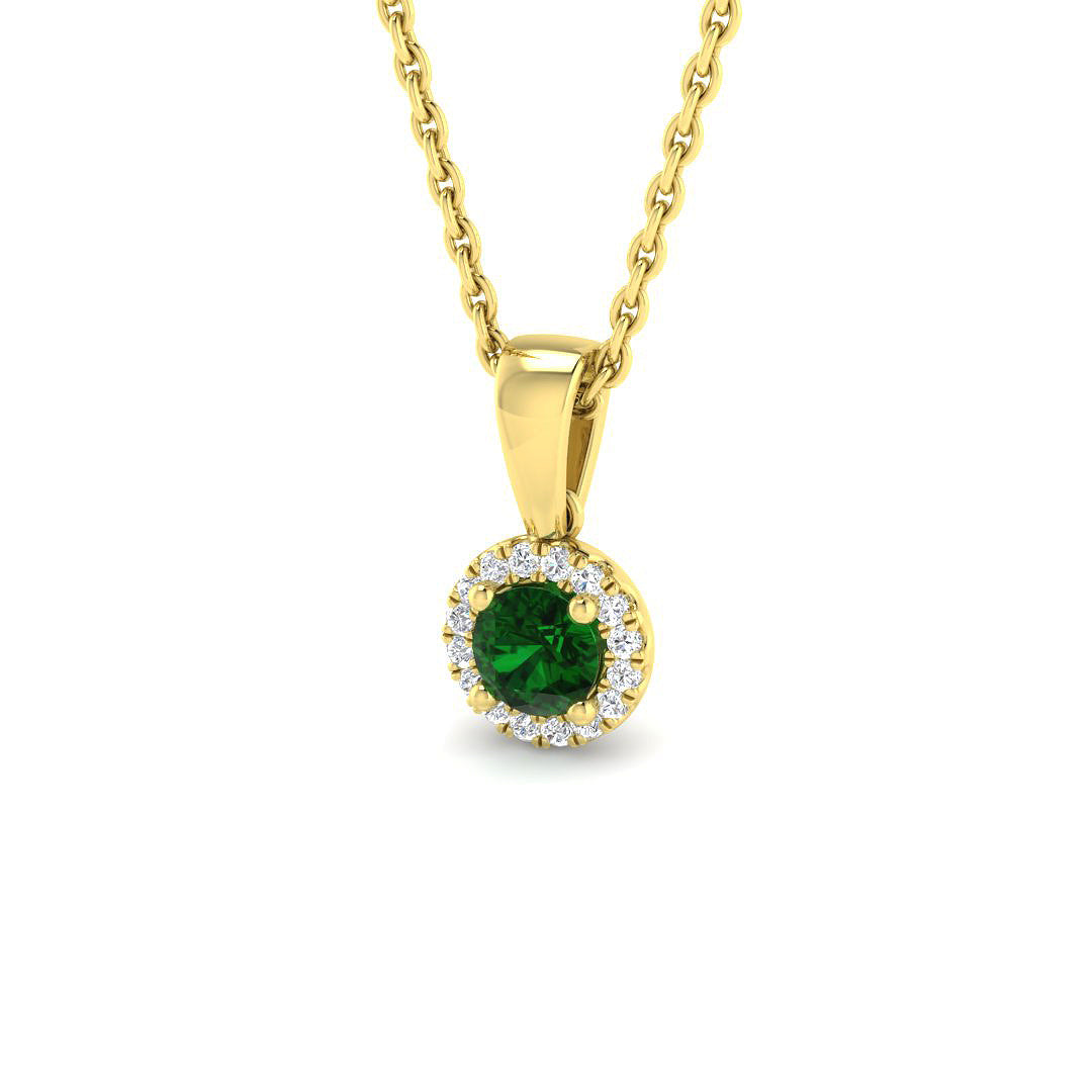 Gold pendant with a green gemstone on a white background