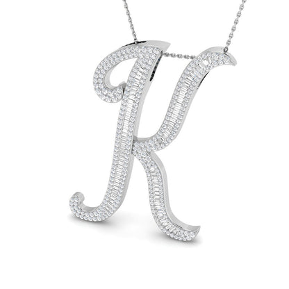 Gold initial pendant with baguette and round cut diamonds.