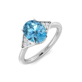 Oval Cut Blue Topaz Ring with Round Side Stones in White Gold