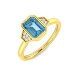 Emerald Cut Blue Topaz Side Stone Ring in Gold