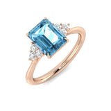 Rose Gold Sky Blue Topaz Solitaire Ring with Side Diamonds