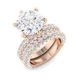 Rose gold ring with a large diamond and smaller diamonds on a white background