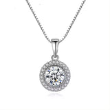 A round solitaire lab grown diamond halo pendant necklace in gold, with a pave setting and a silver chain.