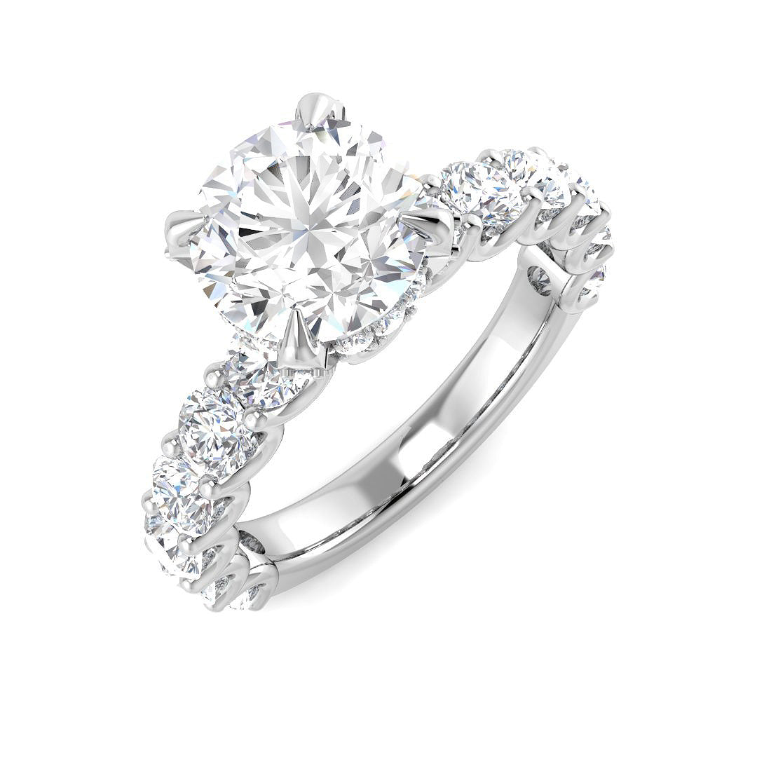 Diamond ring with a central gemstone and smaller stones on a white background