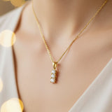 Gold necklace with a diamond pendant on a mannequin