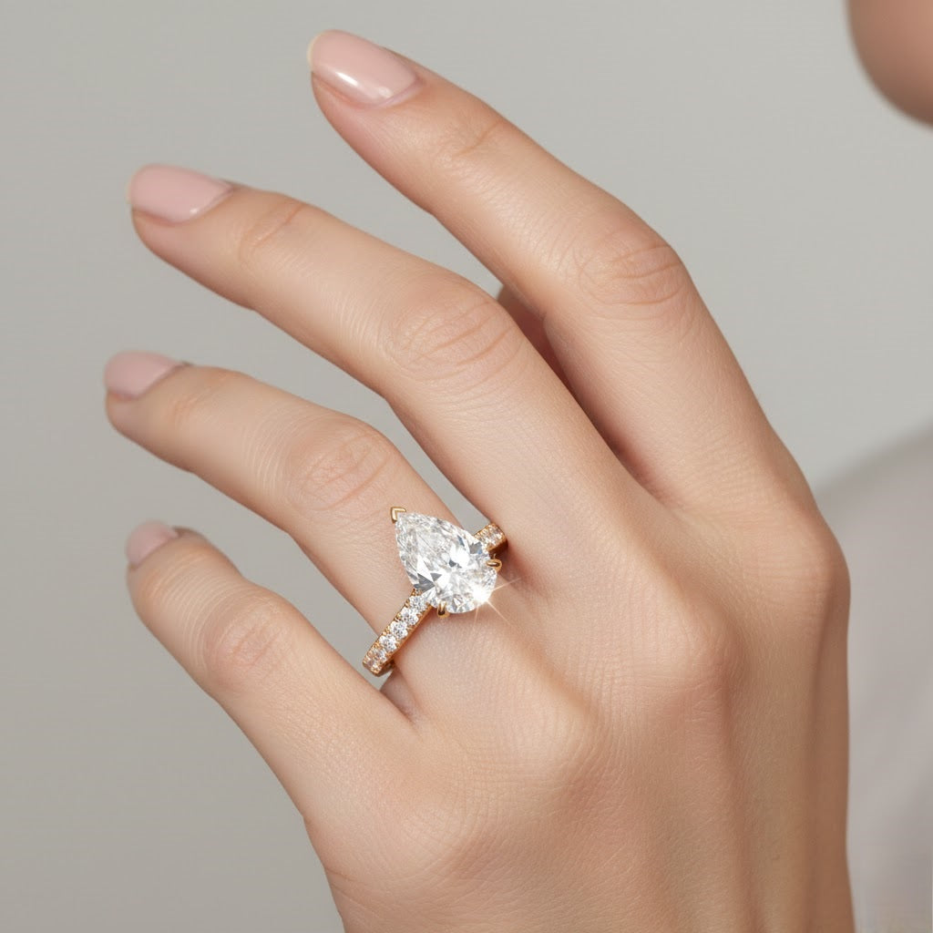 Yellow gold pear shape diamond ring with pavé detailing