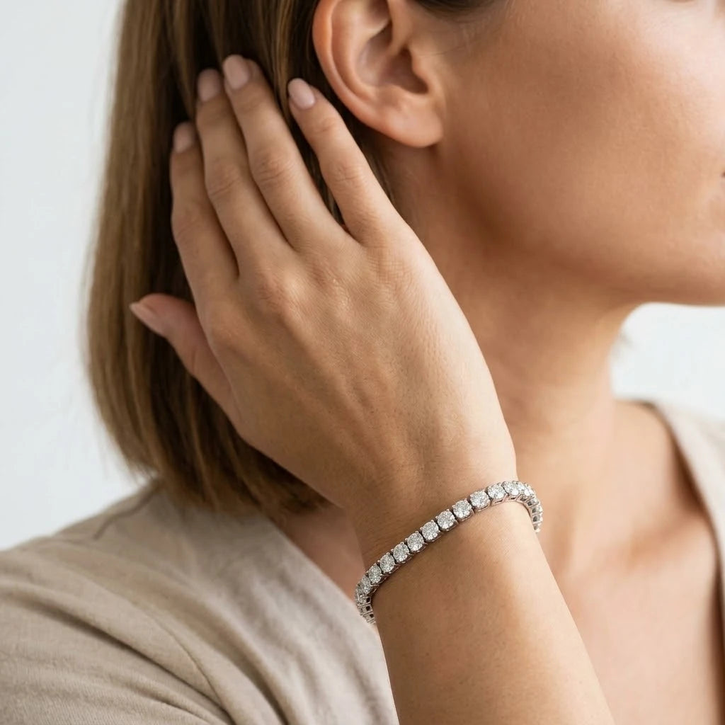  FineDiam tennis bracelet with closely set round diamonds and decorative white metal links.