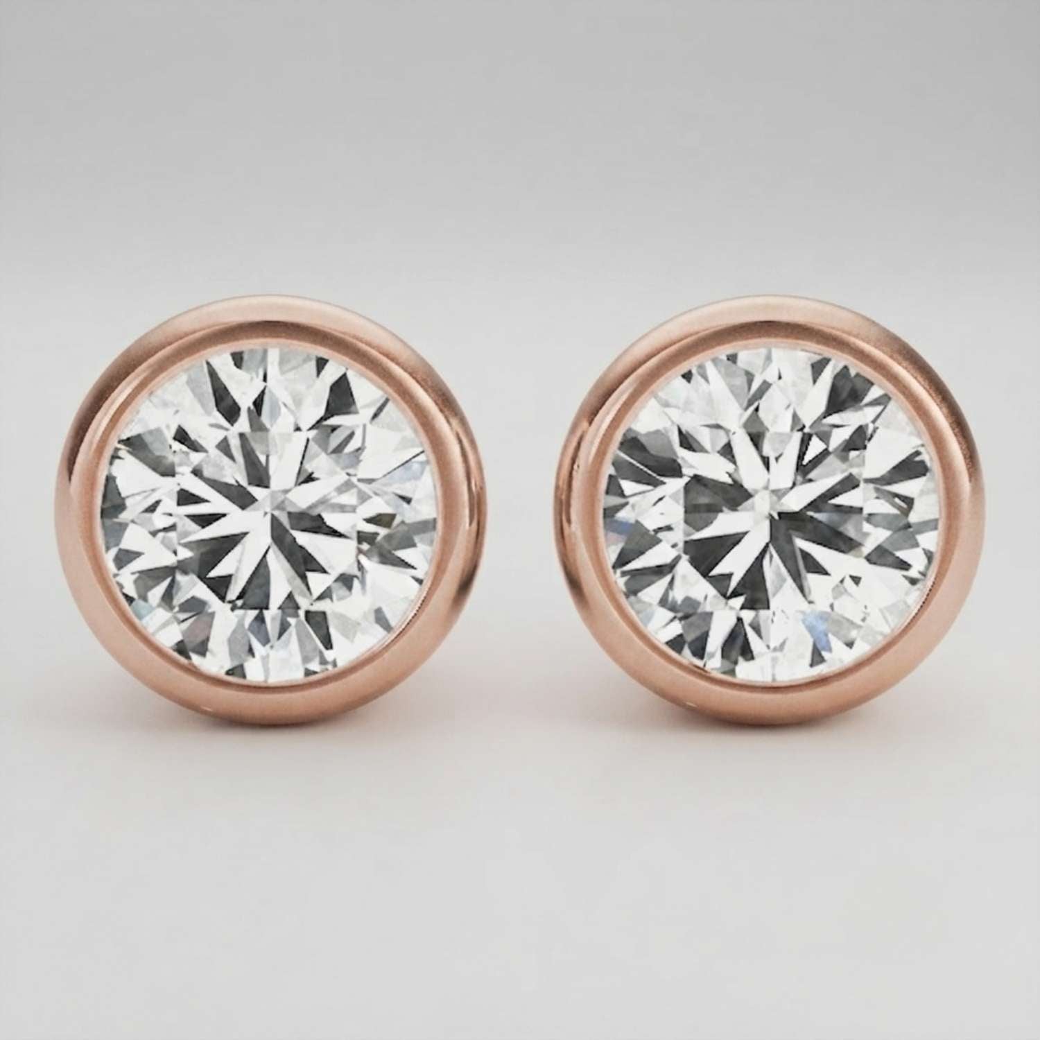 Detailed macro shot of a D color VVS clarity bezel diamond stud with a polished finish.