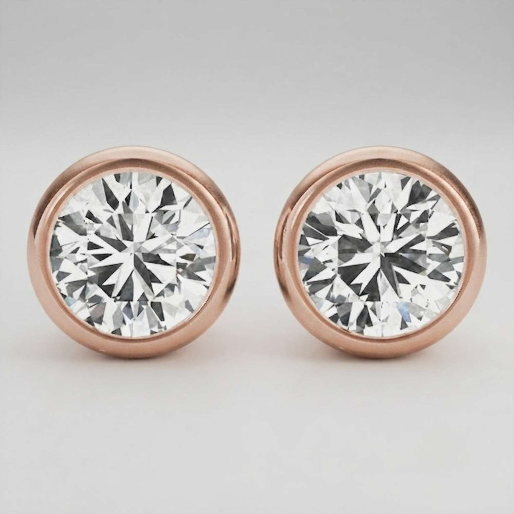 Detailed macro shot of a D color VVS clarity bezel diamond stud with a polished finish.