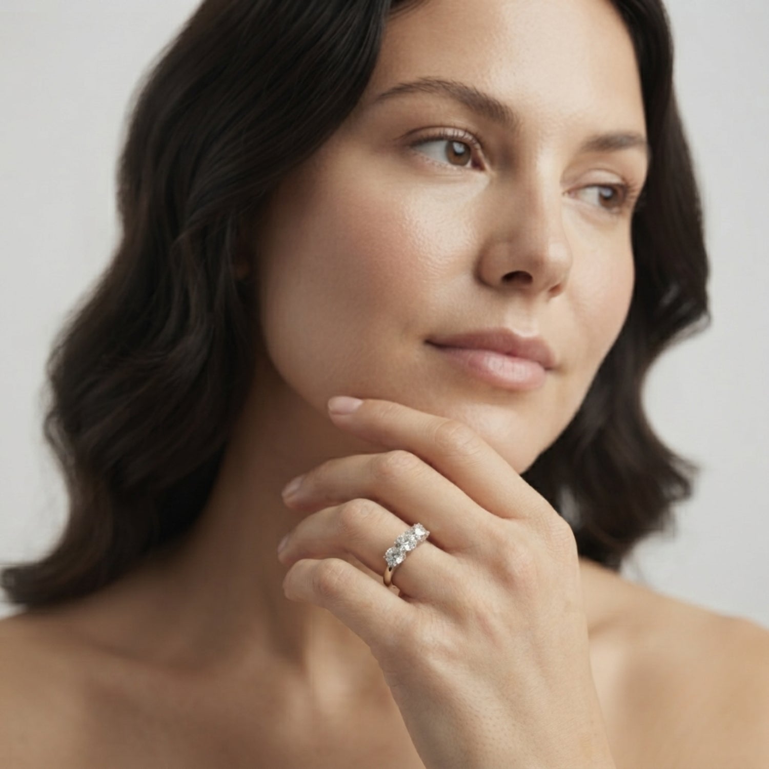 Close-up of a DE colour, VS clarity round diamond trilogy ring showcasing exceptional sparkle and brilliance.
