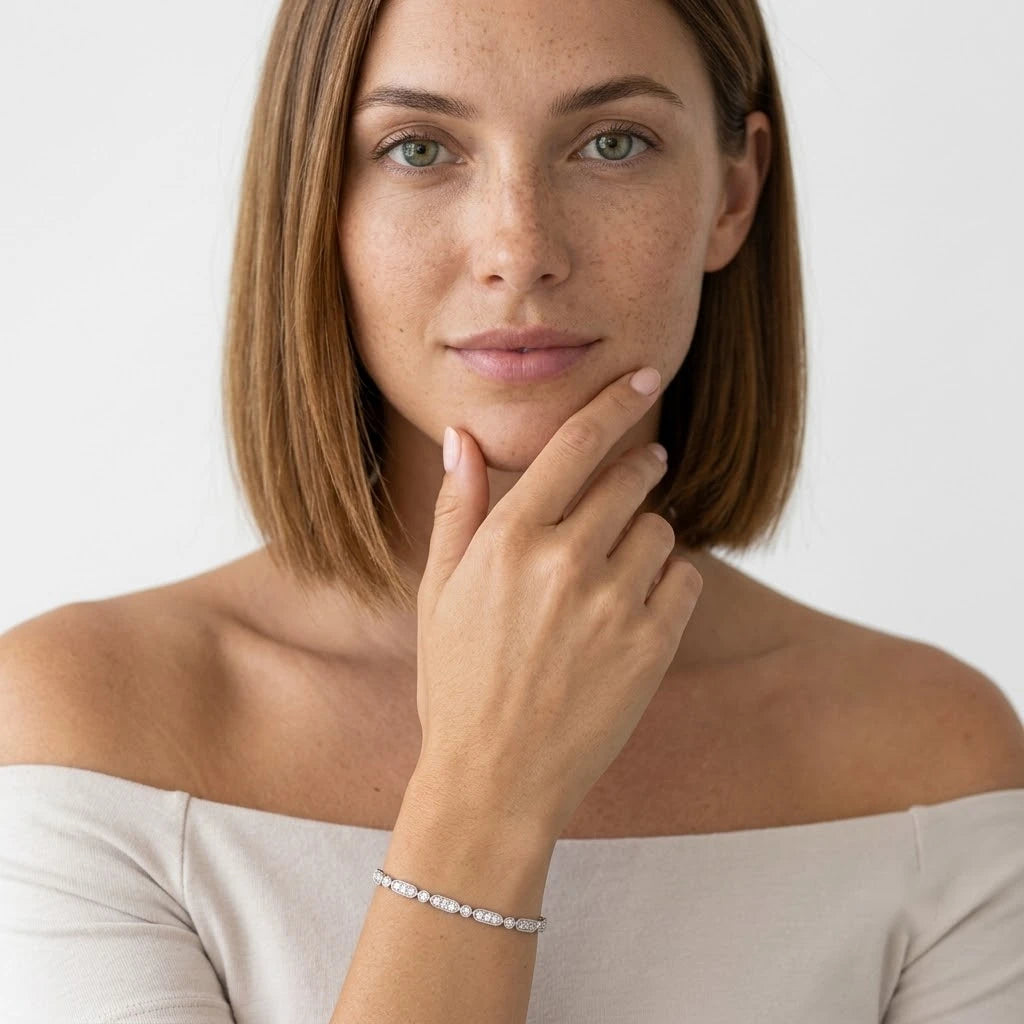 FineDiam white metal bracelet featuring diamond set oval links connected by sparkling round stone accents.