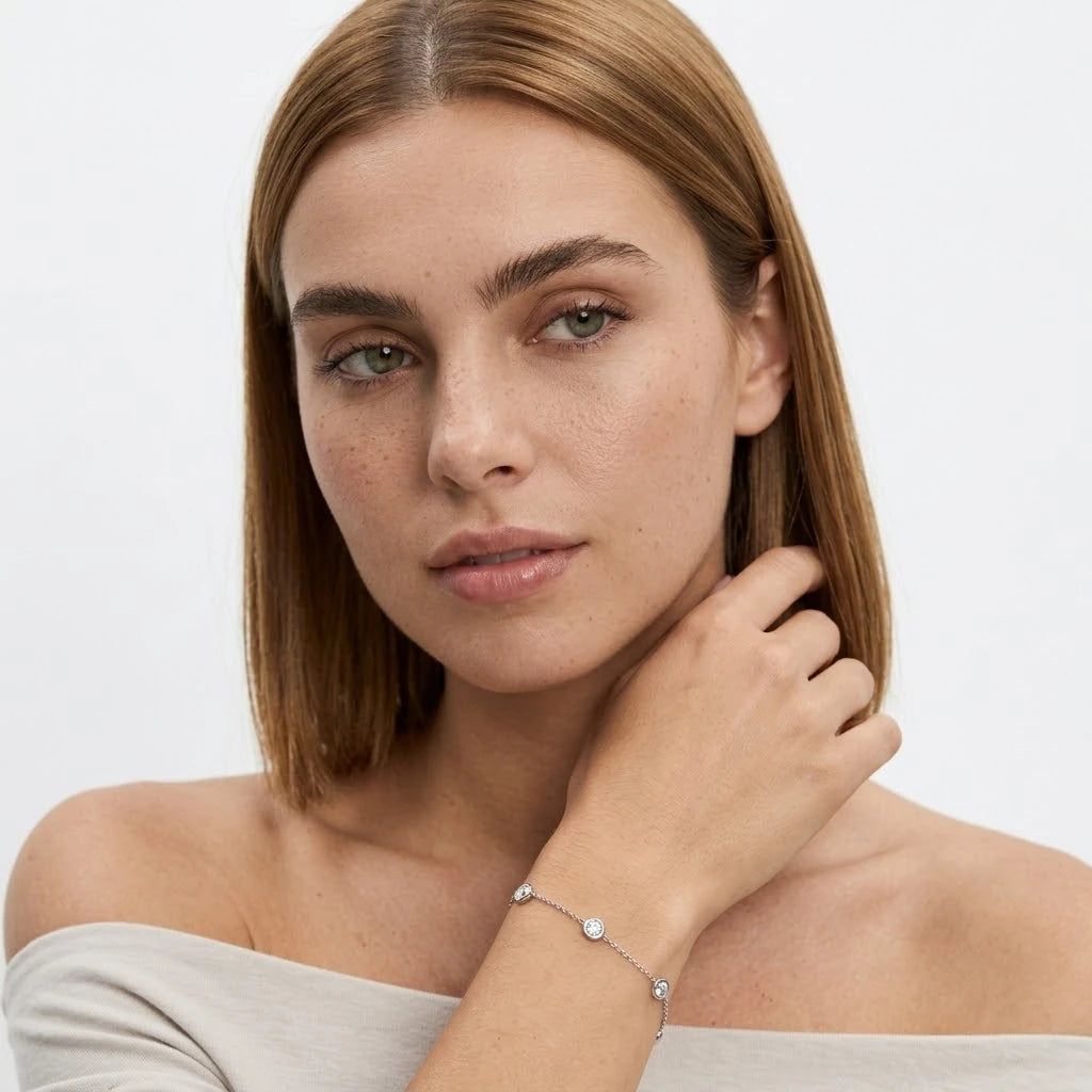 FineDiam round diamond bezel set bracelet with a fine white metal chain and evenly spaced circular settings.