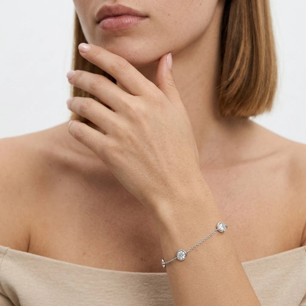 FineDiam bezel set diamond chain bracelet featuring round sparkling stones in polished white metal settings.