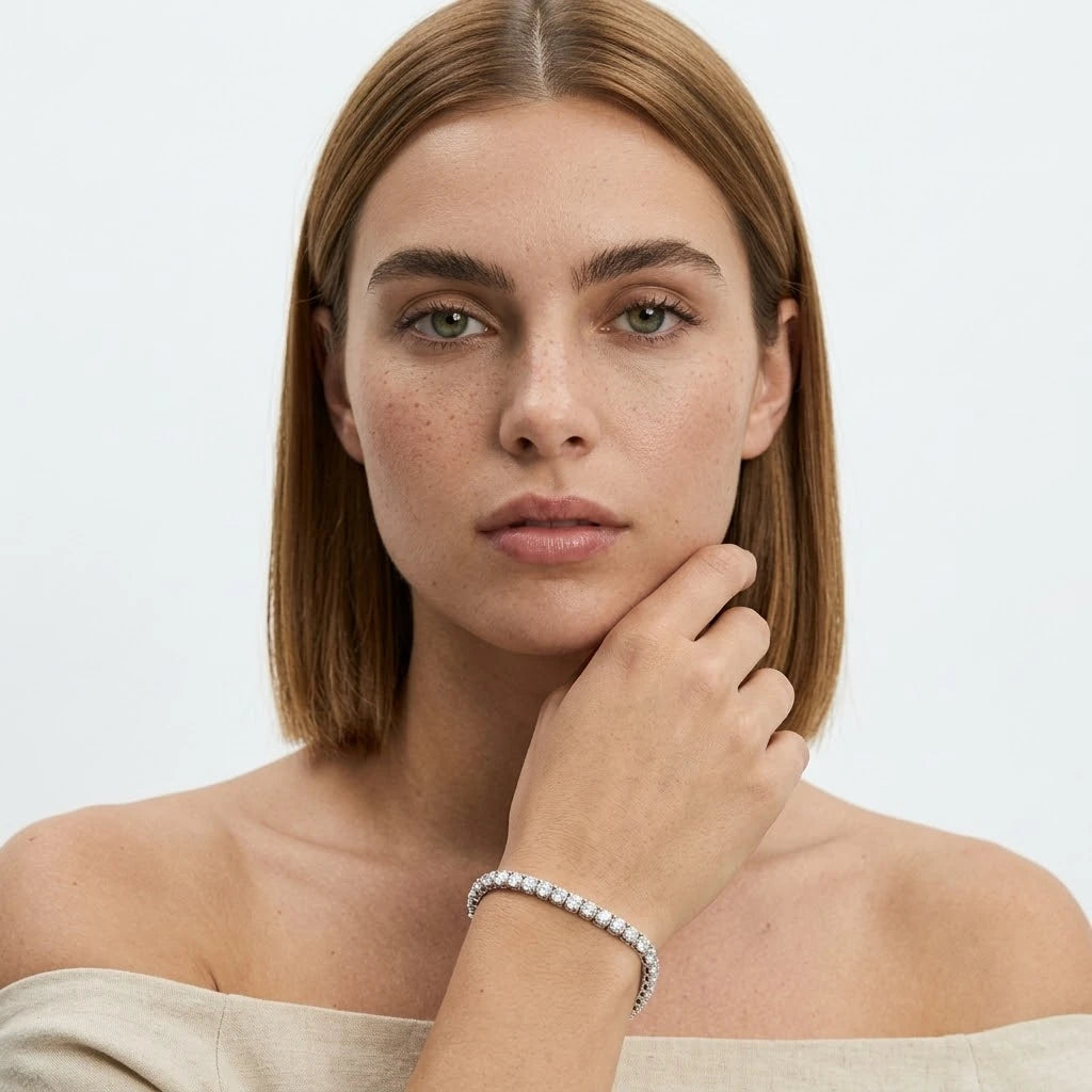 FineDiam diamond tennis bracelet featuring a continuous row of round stones in polished white metal settings.