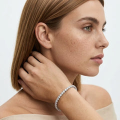 FineDiam round diamond tennis bracelet featuring individual stone settings and detailed open sides.