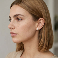 FineDiam pear diamond halo stud earrings featuring a teardrop-shaped setting with sparkling small stones.