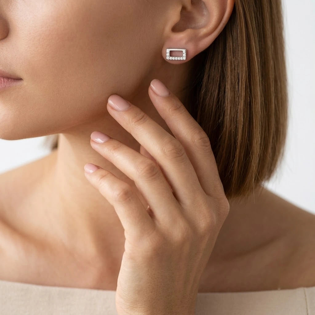 FineDiam geometric rectangular diamond stud earrings featuring an open centre and a sparkling pave border.