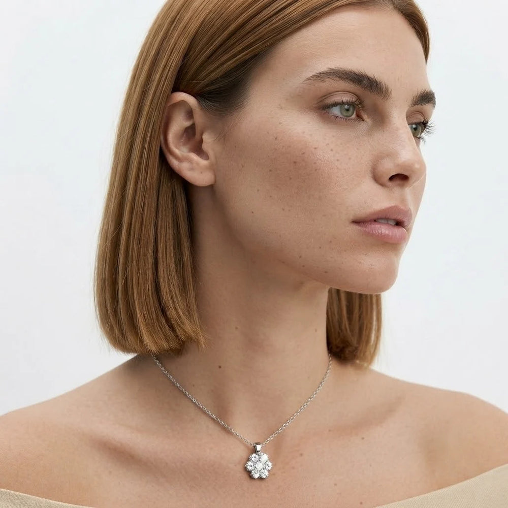 FineDiam floral diamond cluster pendant with round stones arranged in a flower design on a delicate white metal chain.