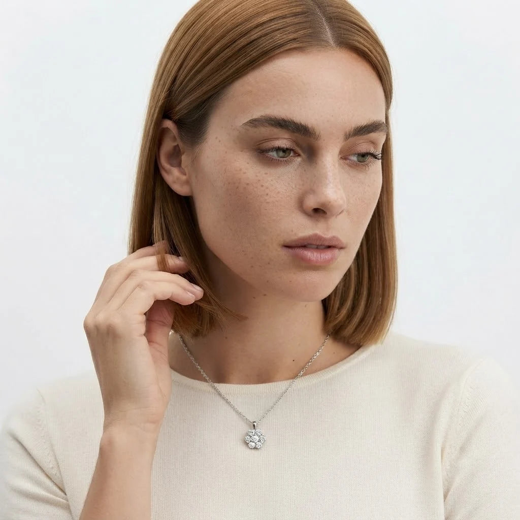 FineDiam diamond flower pendant featuring closely arranged round stones and a polished white metal chain.