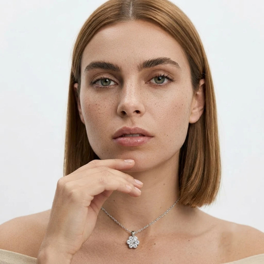 FineDiam floral diamond cluster necklace with a sparkling flower-shaped pendant suspended from a white metal chain.