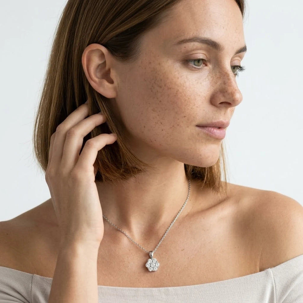 FineDiam diamond flower pendant featuring a round stone cluster in polished white metal with a fine chain.