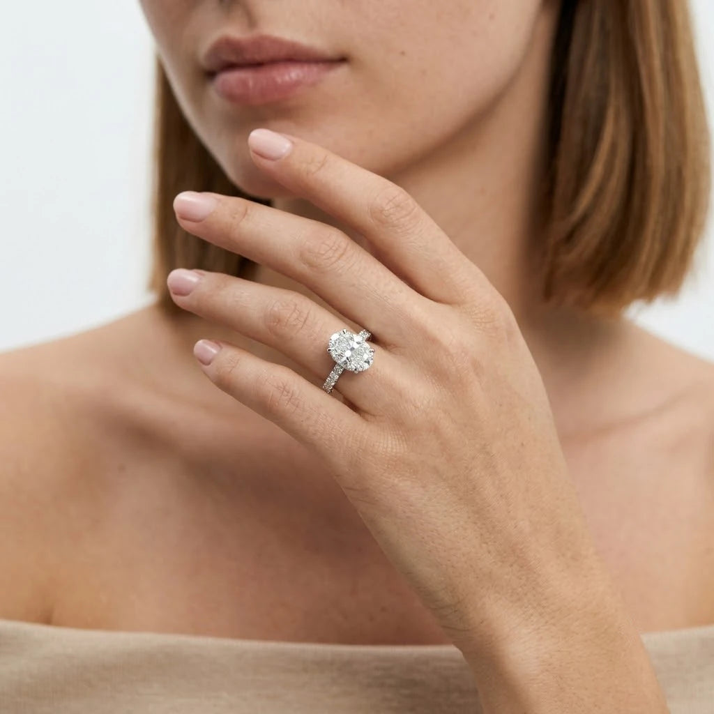 FineDiam diamond cluster ring featuring a four petal floral arrangement of sparkling round stones in white metal.
