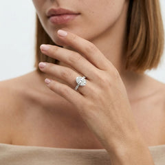 FineDiam diamond cluster ring featuring a four petal floral arrangement of sparkling round stones in white metal.
