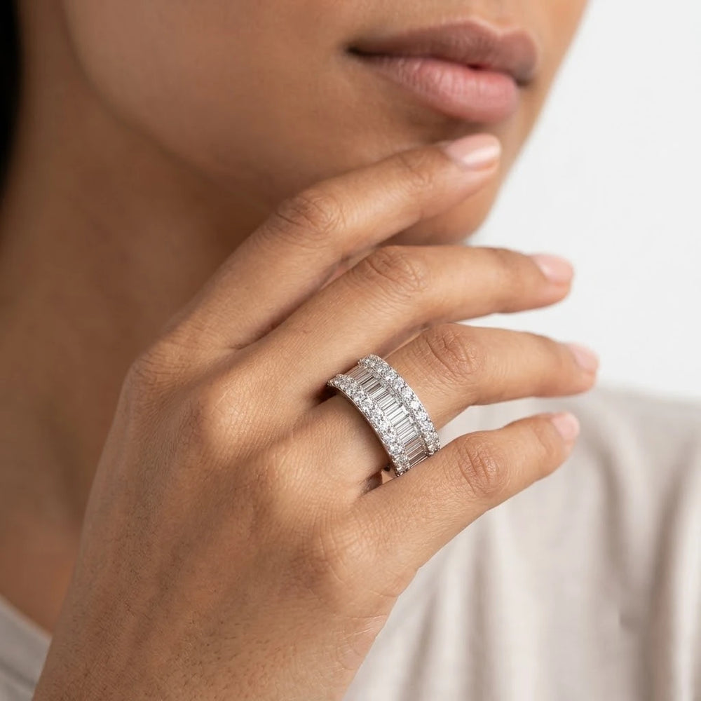 FineDiam wide diamond ring with a central row of baguette cut stones and sparkling round diamond borders.