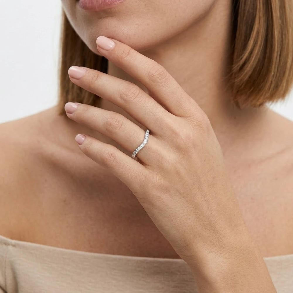 FineDiam curved diamond wedding ring with closely set round stones following a delicate wave-shaped band.